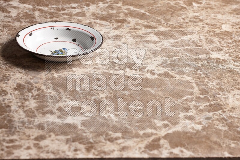 A vintage metal plate on beige marble background