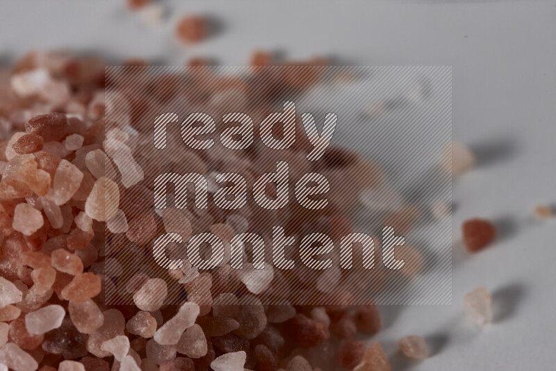 A bunch of coarse himalayan salt crystals on white background