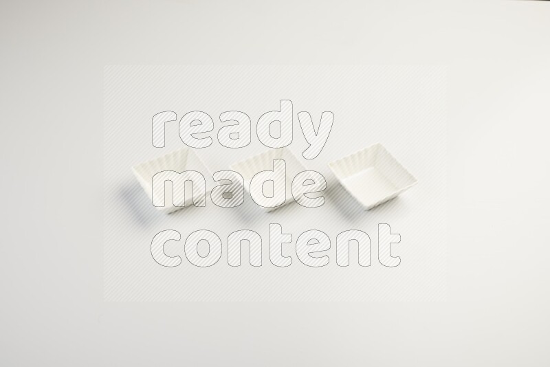 white ceramic square sauce dish on white countertop