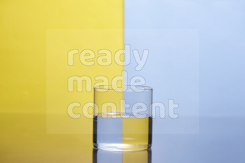 The image features a clear glassware filled with water, set against yellow and light blue background
