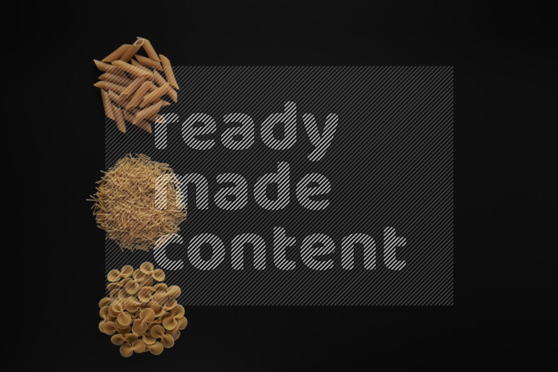 Different pasta types in 3 bunches on black background