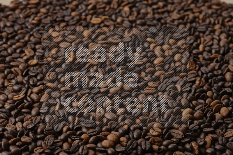 Roasted coffee beans on beige background