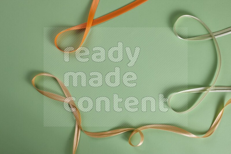 A collection of sewing and tailoring tools arranged on a green background