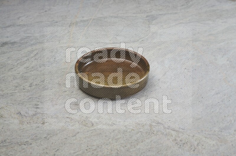 A multicolored pottery oven plate on grey marble background