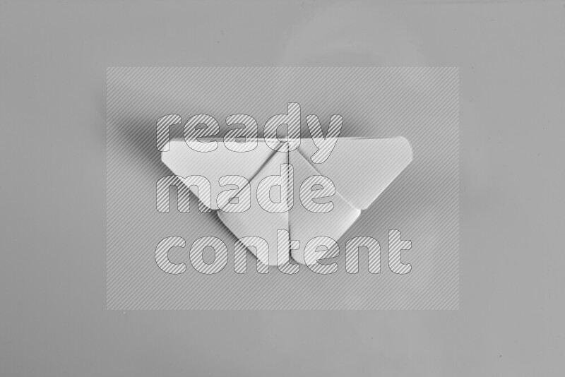 Origami butterfly on grey background