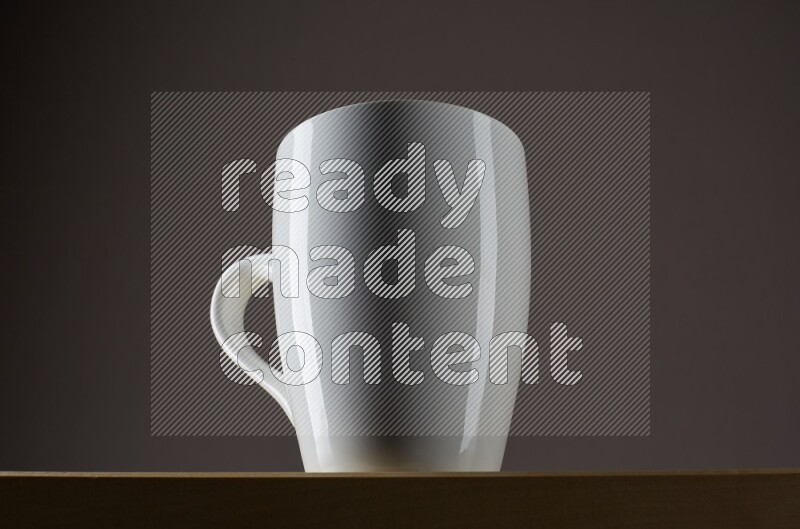 Low angle shot of a white cup on grey background