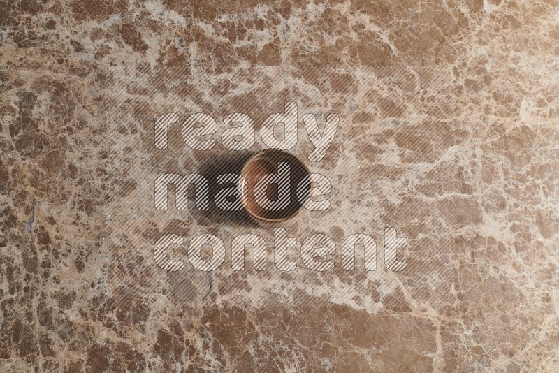 A pottery cup on beige marble background