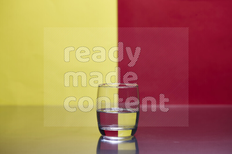 The image features a clear glassware filled with water, set against yellow and red background