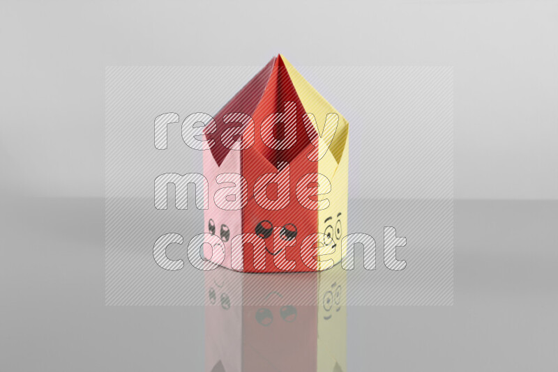Origami pen holder on grey background
