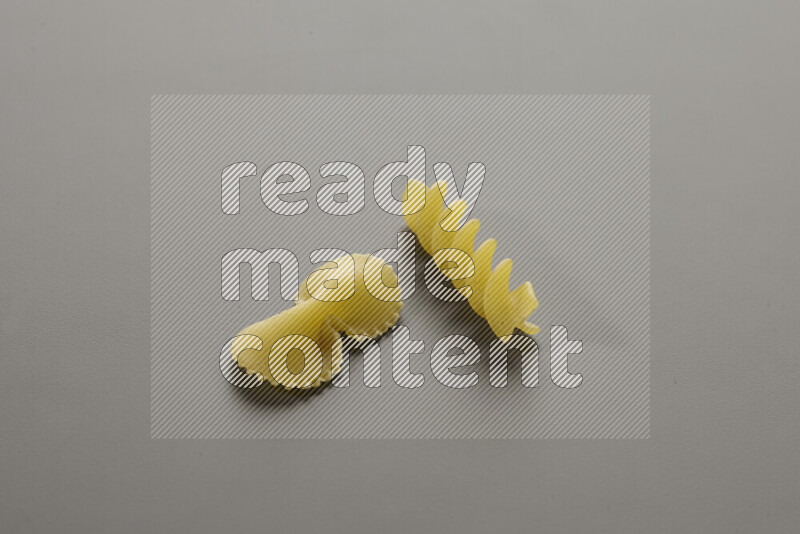 Fiocchi pasta with other types of pasta on grey background