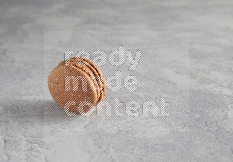 45º Shot of Brown Hazelnuts macaron on white  marble background