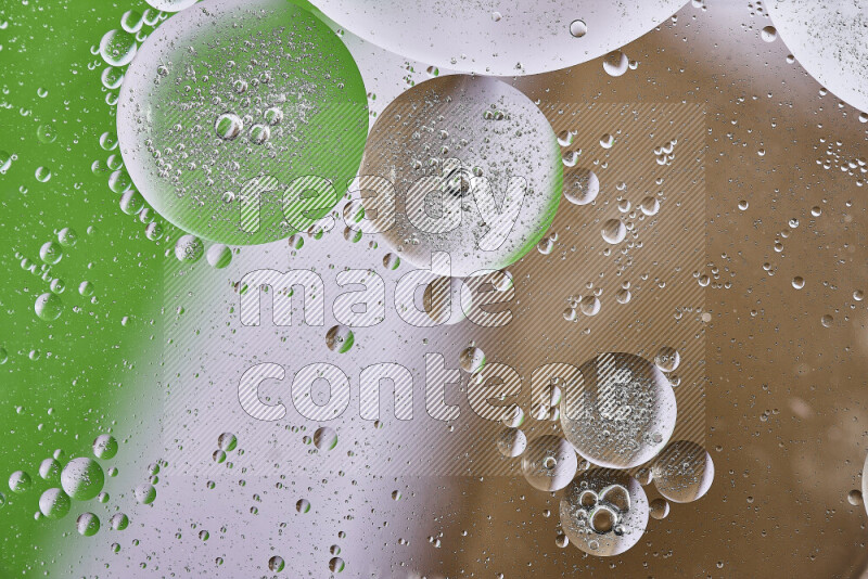 Close-ups of abstract oil bubbles on water surface in shades of brown, green and white