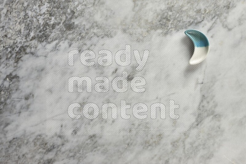 صحن فخاري على شكل هلال على خلفية من الرخام الرمادي