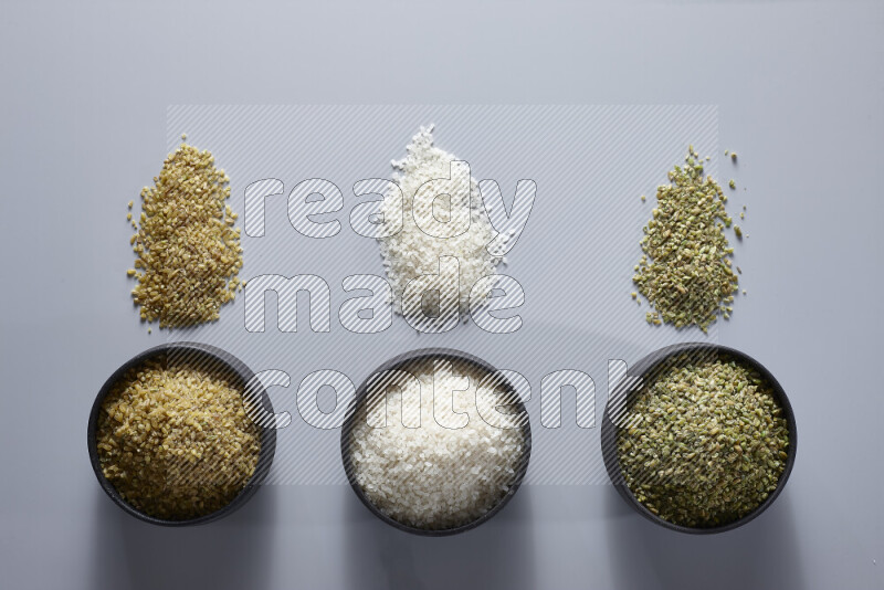 Legumes in pottery bowls on light grey background