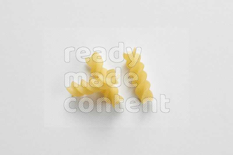 Fusilli pasta on white background