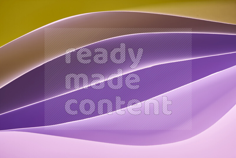 This image showcases an abstract paper art composition with paper curves in purple and gold gradients created by colored light