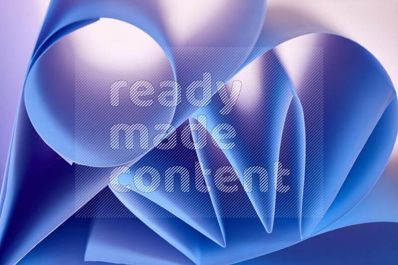 An artistic display of paper folds creating a harmonious blend of geometric shapes, highlighted by soft lighting in blue tones