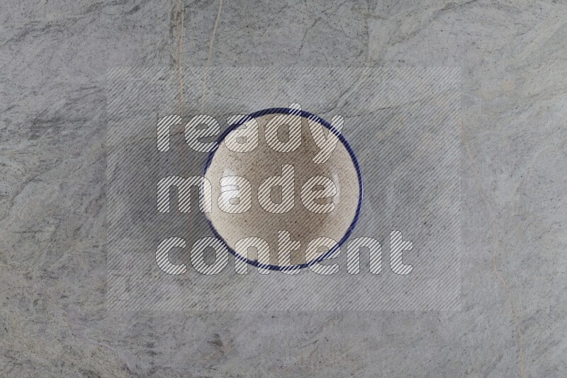 A multicolored pottery Bowl on grey marble background