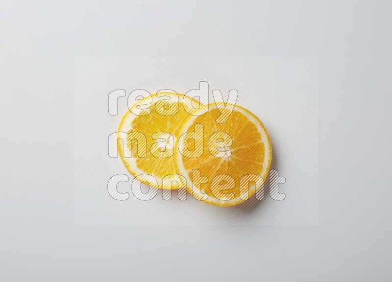 Two orange slices on white background