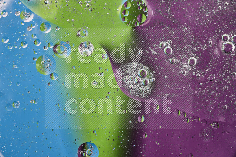 Close-ups of abstract oil bubbles on water surface in shades of purple, green and blue