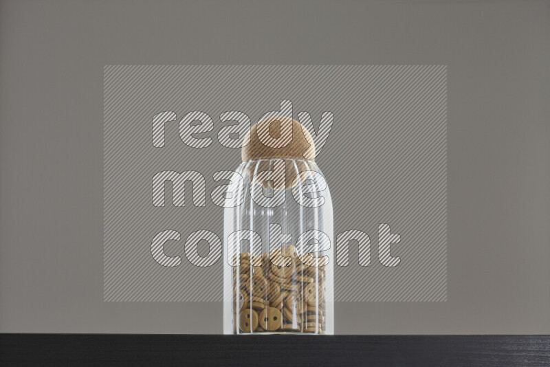 Buttons in a glass jar on black background