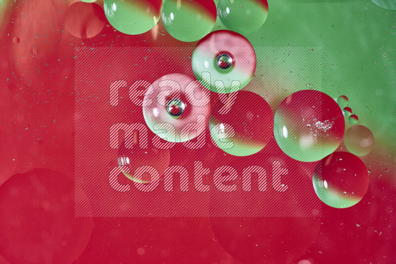 Close-ups of abstract oil bubbles on water surface in shades of green and red