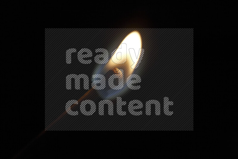 A burning matchstick isolated on dark backdrop