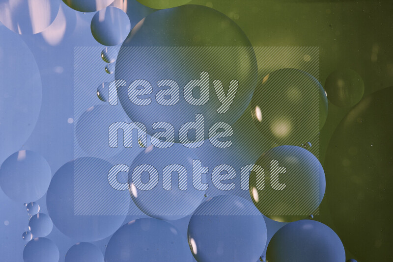 Close-ups of abstract oil bubbles on water surface in shades of blue and green