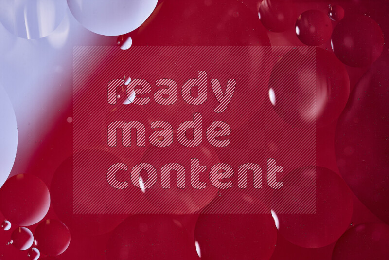 Close-ups of abstract oil bubbles on water surface in shades of white and red