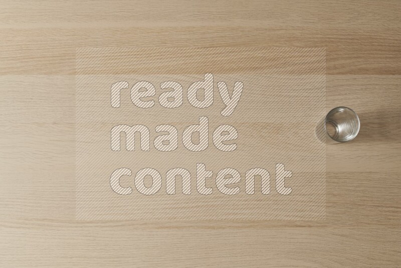 An empty glass cup on light wooden background