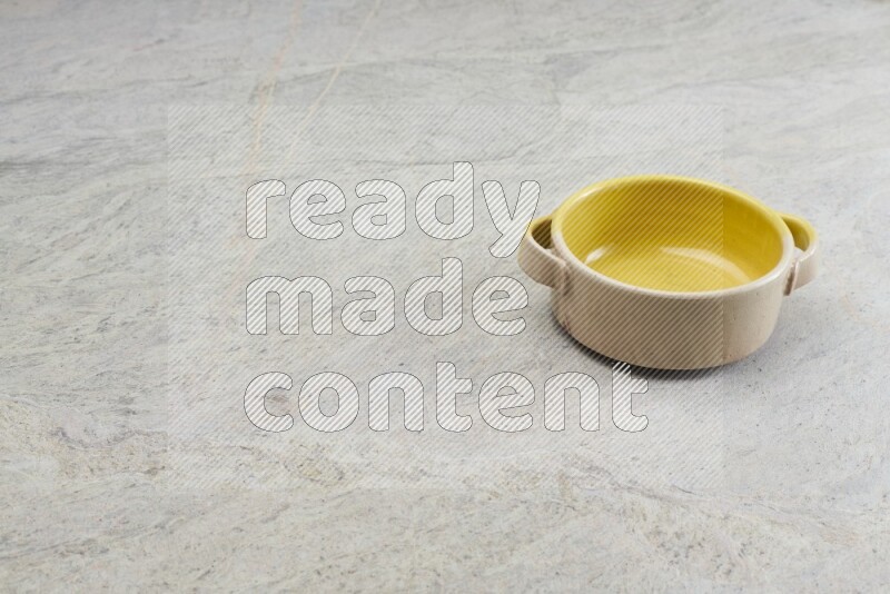A multicolored pottery bowl on grey marble background