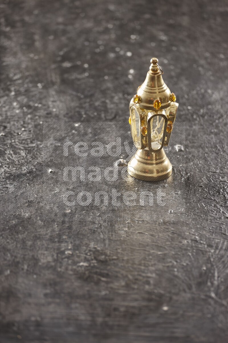 A lantern placed on a textured black background