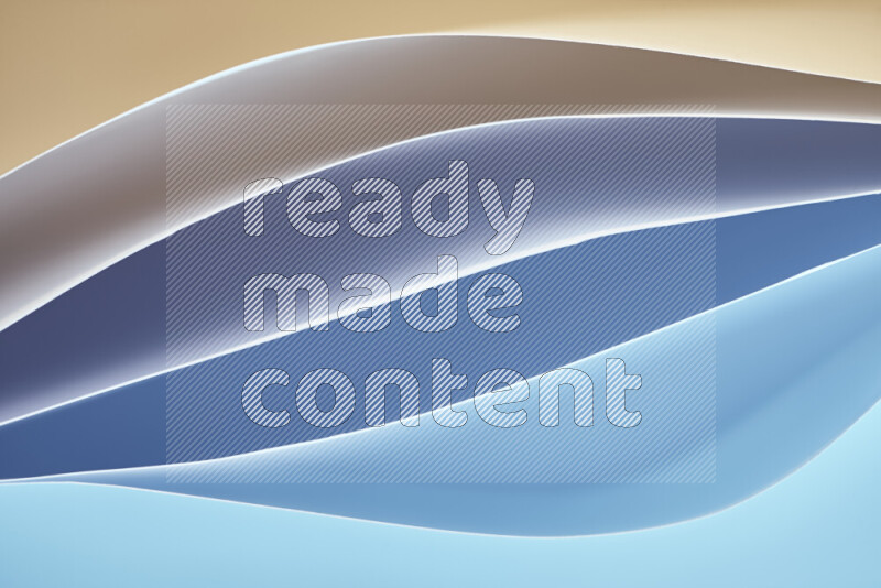 هذه الصورة تعرض تكوين فن الورق التجريدي مع منحنيات ورقية بتدرجات اللون الأزرق والأصفر المكونه بواسطة الضوء الملون