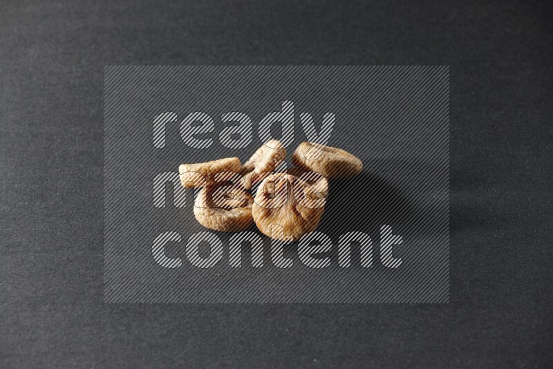Dried figs on a black background in different angles
