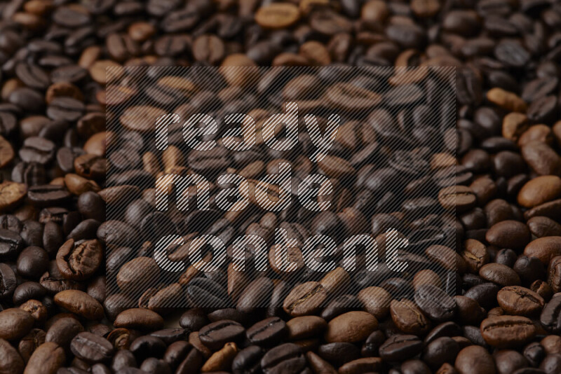 Roasted coffee beans on beige background