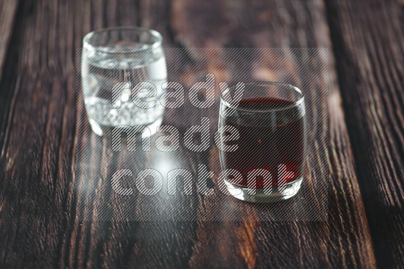 Cold drinks in a glass cup such as water, tamarind, qamar eldin, sobia, milk and hibiscus on wooden background