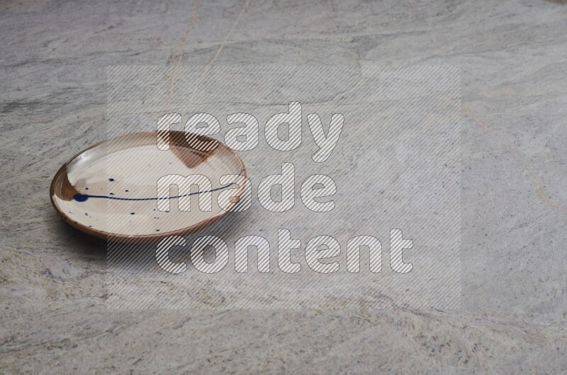 Multicolored Pottery Plate On Grey Marble Flooring