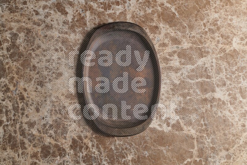A vintage metal tray on beige marble background