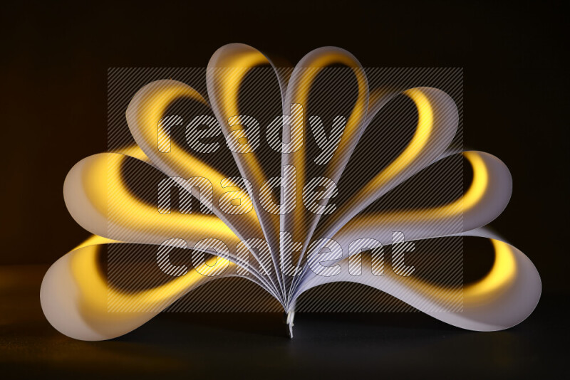 An abstract art piece displaying smooth curves in yellow and white gradients created by colored light
