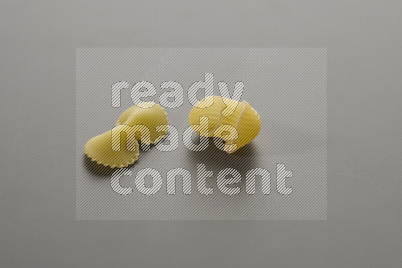 Fiocchi pasta with other types of pasta on grey background