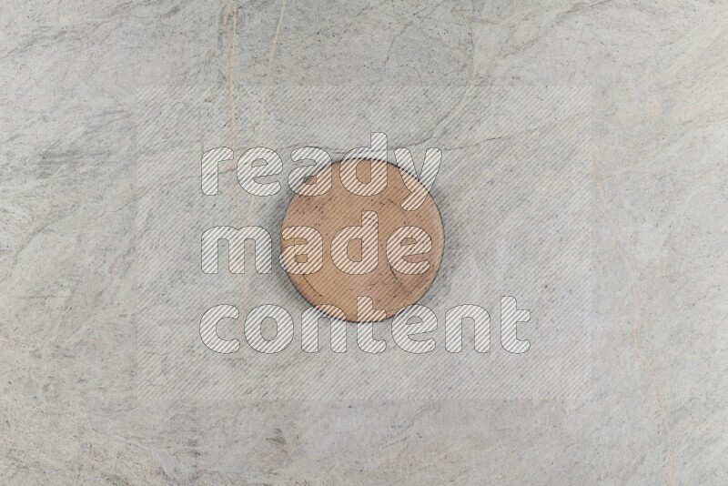A pottery coaster on grey marble background