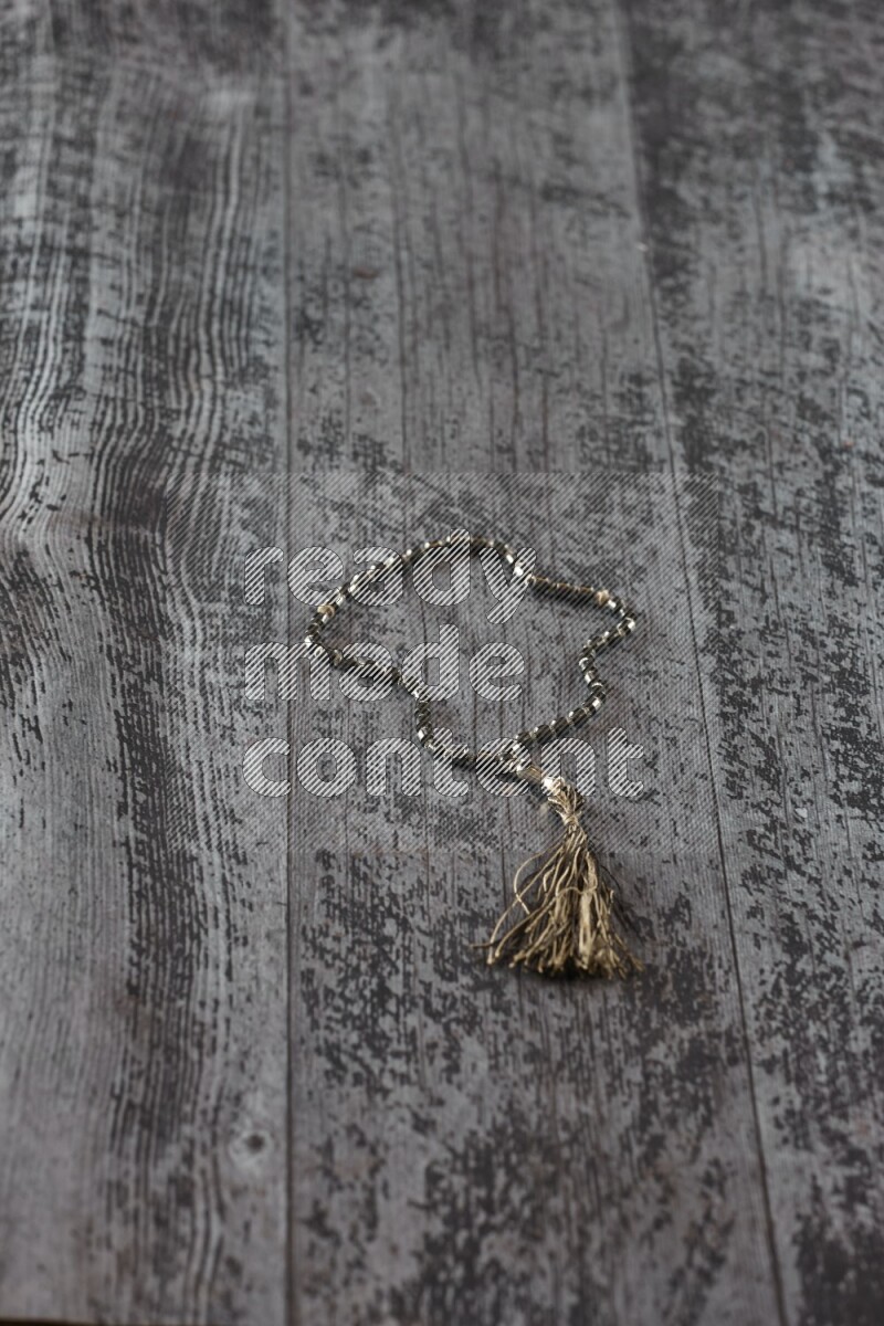 A prayer beads placed on wooden background