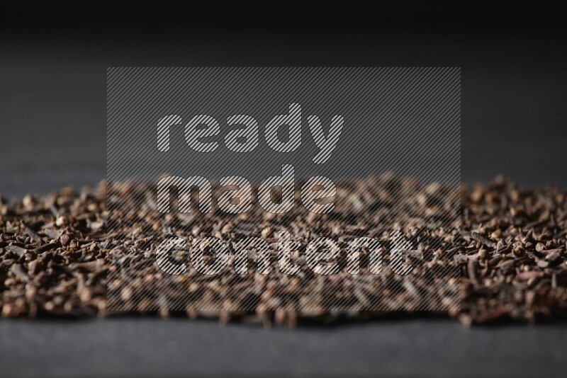 Cloves spread on black flooring