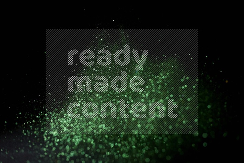 Green glitter powder isolated on black background
