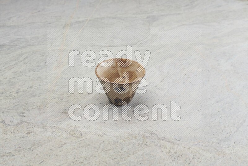 A multicolored pottery Cup on grey marble background