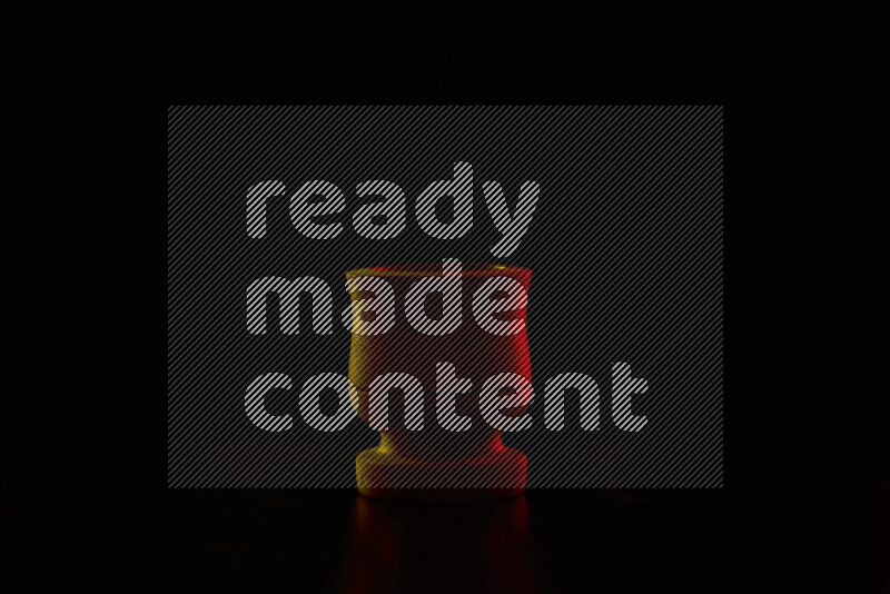 Wooden kitchen essentials with colored rim light against black background