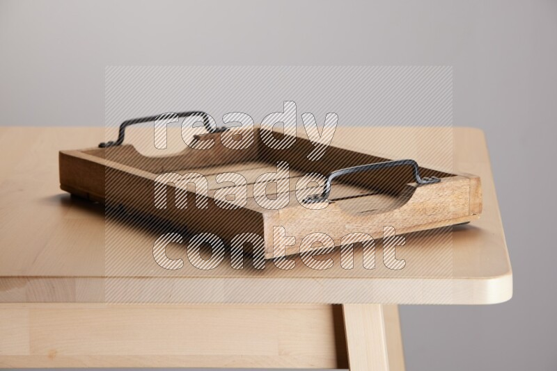 wooden trays and cutting boards on the edge of wooden table