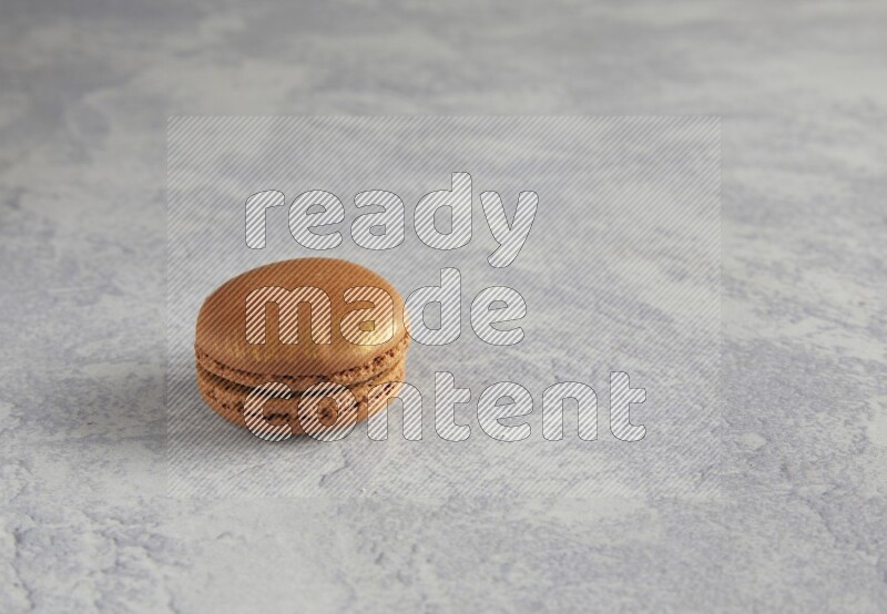 45º Shot of Brown Coffee macaron on white  marble background
