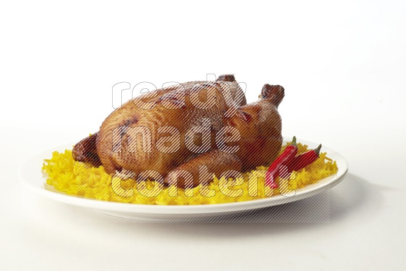 yellow  basmati Rice with  whole roasted chicken on a white rounded plate direct on white background