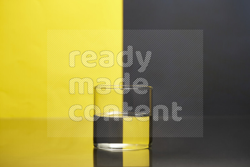 The image features a clear glassware filled with water, set against yellow and black background